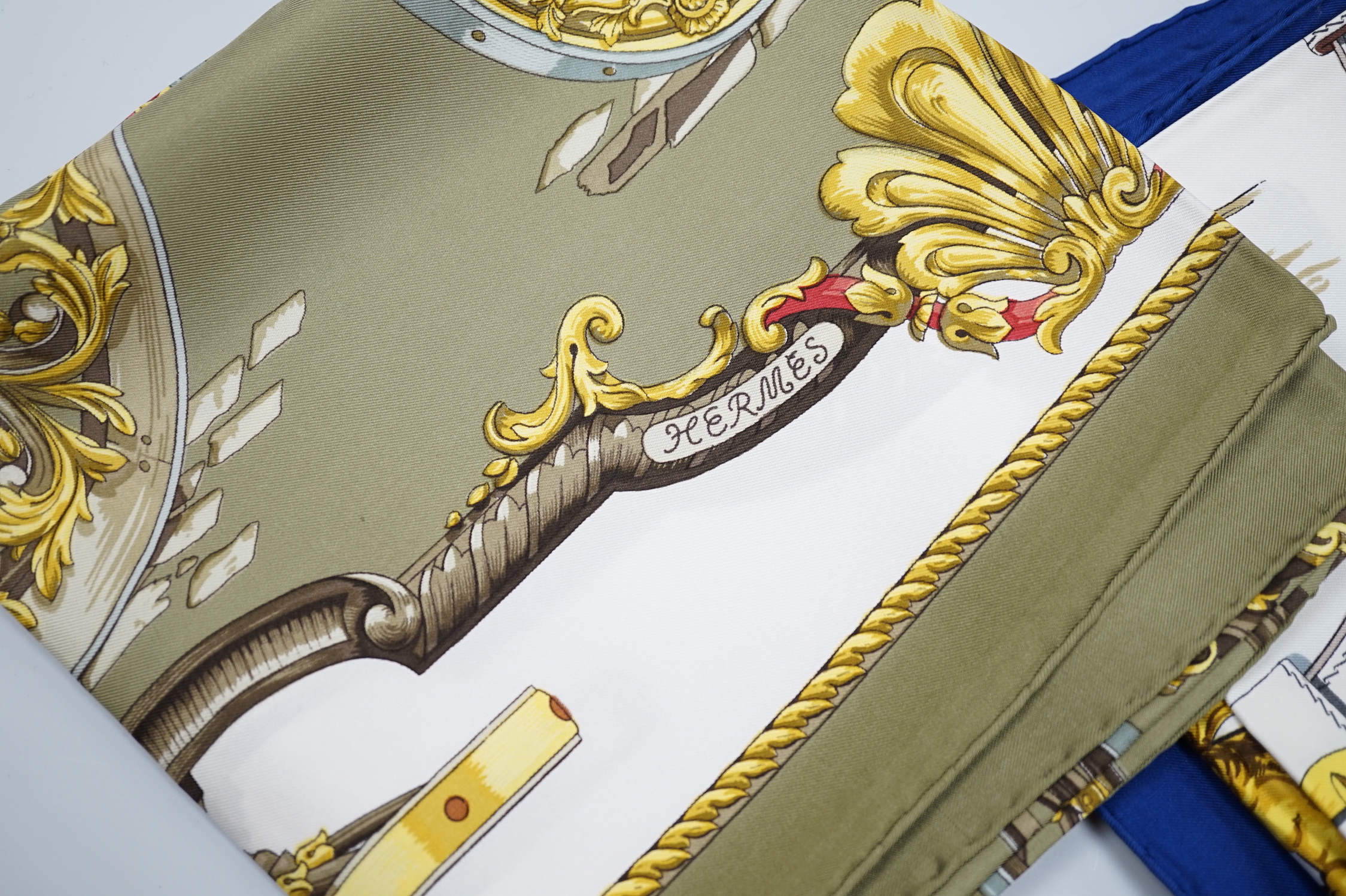 Four vintage Hermes silk scarves comprising Cosmos, Bride de Cour, Roues de Canon and a Cuivreries example retailed by Harrods